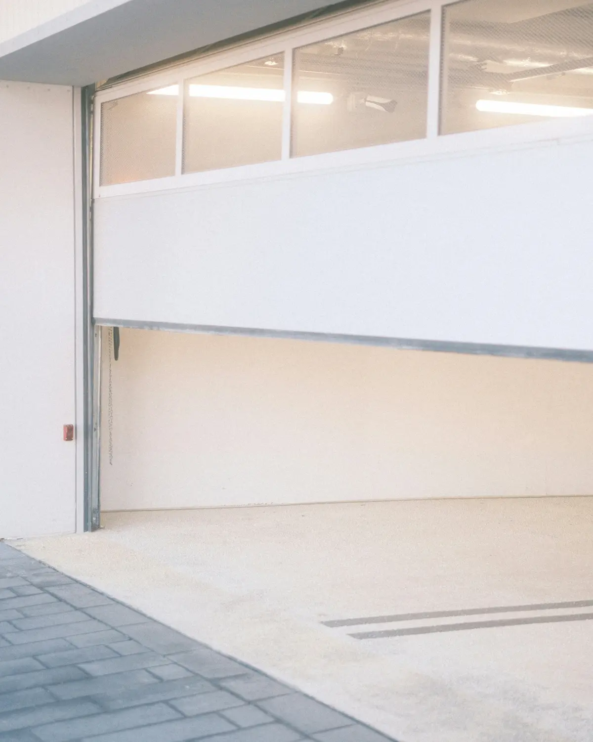 Open residential garage door showing connected sectional panels