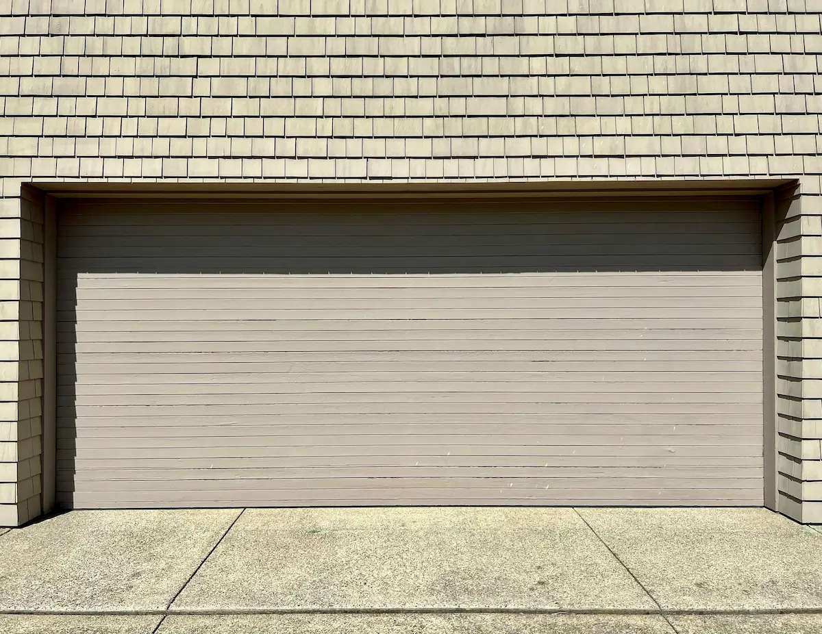 Garage door with decorative replacement panel design